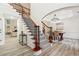Bright foyer showcasing a staircase with wood and wrought iron, plus stylish flooring and decor at 4419 Bellwood Cir, Atlanta, GA 30349