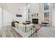 Open-concept living room features tall ceilings, fireplace, and a large window with natural light at 4419 Bellwood Cir, Atlanta, GA 30349