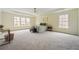 Expansive Primary bedroom featuring tray ceilings, large windows, and ample space at 4419 Bellwood Cir, Atlanta, GA 30349