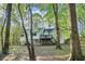 Lush backyard featuring mature trees, a charming fence, and an expansive lawn area at 2100 Kings Valley Dr, Lawrenceville, GA 30043