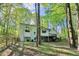Spacious backyard with mature trees and a wooden fence around the property at 2100 Kings Valley Dr, Lawrenceville, GA 30043