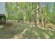 Explore the expansive backyard, partially fenced and adorned with towering trees and lush greenery at 2100 Kings Valley Dr, Lawrenceville, GA 30043