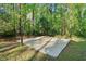Recreational concrete basketball court nestled within a tree-lined backyard setting at 2100 Kings Valley Dr, Lawrenceville, GA 30043