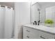 Bathroom featuring a tub with shower curtain, white vanity with marble countertop, and modern black faucet at 2100 Kings Valley Dr, Lawrenceville, GA 30043