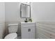 Stylish half bath with white shiplap accent wall, modern vanity, and sleek fixtures at 2100 Kings Valley Dr, Lawrenceville, GA 30043