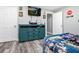 Cozy bedroom with stylish decor, including hardwood floors, soft lighting, and a blue cabinet at 2100 Kings Valley Dr, Lawrenceville, GA 30043