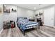 Cozy bedroom with stylish decor, including hardwood floors, soft lighting, and decorative shelves at 2100 Kings Valley Dr, Lawrenceville, GA 30043