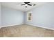 Bedroom featuring light blue walls, neutral carpet, and a window with a view of the outdoors at 2100 Kings Valley Dr, Lawrenceville, GA 30043