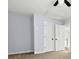 Neutral bedroom featuring two white doors, ceiling fan, and carpeted floors at 2100 Kings Valley Dr, Lawrenceville, GA 30043