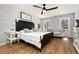 Comfortable bedroom featuring hardwood floors, shiplap accent wall, and plenty of natural light at 2100 Kings Valley Dr, Lawrenceville, GA 30043