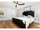 Cozy bedroom with hardwood floors, a black accent bed frame, and an inviting atmosphere at 2100 Kings Valley Dr, Lawrenceville, GA 30043