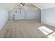Large bonus room featuring light blue walls, neutral carpet, and a dormer window providing natural light at 2100 Kings Valley Dr, Lawrenceville, GA 30043