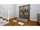 Charming foyer area featuring hardwood floors, staircase, and plenty of sunlight at 2100 Kings Valley Dr, Lawrenceville, GA 30043