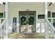 Charming front door entrance with a welcome sign and beautiful wreaths on the doors at 2100 Kings Valley Dr, Lawrenceville, GA 30043
