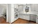 Modern kitchen with white cabinets, stainless steel appliances, and a breakfast bar at 2100 Kings Valley Dr, Lawrenceville, GA 30043