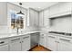 Bright kitchen features white cabinets, stainless steel appliances, and a window overlooking the yard at 2100 Kings Valley Dr, Lawrenceville, GA 30043