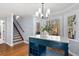 Inviting kitchen area with blue kitchen island, custom tiled staircase, and plenty of natural light at 2100 Kings Valley Dr, Lawrenceville, GA 30043