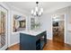 Open kitchen design with blue kitchen island, marble countertop, and hardwood floors, perfect for entertaining at 2100 Kings Valley Dr, Lawrenceville, GA 30043