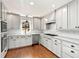 Modern kitchen featuring white cabinetry, stainless steel appliances, and sleek countertops at 2100 Kings Valley Dr, Lawrenceville, GA 30043