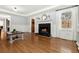 Cozy living room features a fireplace, hardwood floors, and natural light from a large window at 2100 Kings Valley Dr, Lawrenceville, GA 30043