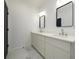 Bathroom featuring double sinks, large mirrors, and modern lighting at 2526 Abner Nw Pl, Atlanta, GA 30318