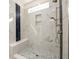 Modern shower with marble-style tile, rainfall showerhead, and a built-in bench at 2526 Abner Nw Pl, Atlanta, GA 30318