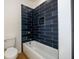 Bathroom with a tub and modern navy subway tile surround at 2526 Abner Nw Pl, Atlanta, GA 30318