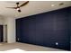 Bedroom with a navy accent wall and a ceiling fan at 2526 Abner Nw Pl, Atlanta, GA 30318