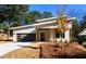 Charming modern home featuring sleek design, gray garage door, and tasteful landscaping at 2526 Abner Nw Pl, Atlanta, GA 30318