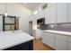 Modern kitchen with white cabinets, stainless appliances, beautiful backsplash and blue island at 2526 Abner Nw Pl, Atlanta, GA 30318