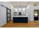 Modern kitchen boasting a blue island, pendant lighting, stainless appliances, and hardwood floors at 2526 Abner Nw Pl, Atlanta, GA 30318