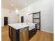 Modern kitchen with a white countertop island and a farmhouse sink illuminated by pendant lighting at 2526 Abner Nw Pl, Atlanta, GA 30318