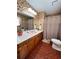 Vintage-style bathroom with unique wallpaper and a pink sink for a nostalgic touch at 3415 Spot Rd, Cumming, GA 30040