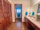 Functional bathroom featuring wood cabinets, a single sink vanity, and a shower-tub combination at 3415 Spot Rd, Cumming, GA 30040