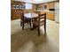 Dining area with wooden table and chairs next to a kitchen with updated appliances at 3415 Spot Rd, Cumming, GA 30040