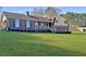 Traditional two-story home with brick and siding exterior, front porch and expansive green front lawn at 3415 Spot Rd, Cumming, GA 30040