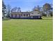 Charming brick home with a sprawling green lawn and inviting front porch at 3415 Spot Rd, Cumming, GA 30040