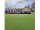 Two-story house with a brick facade and a cozy front porch, situated on an expansive green lawn at 3415 Spot Rd, Cumming, GA 30040