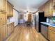 Kitchen featuring stainless steel appliances and hardwood floors with open doorway at 3415 Spot Rd, Cumming, GA 30040