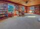 Inviting living room with wood-paneled walls, built-in bookshelves, and a ceiling fan for added comfort at 3415 Spot Rd, Cumming, GA 30040
