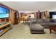 Open-concept living room with a large TV, dining table, and wood-paneled walls at 3415 Spot Rd, Cumming, GA 30040