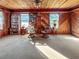 Cozy living room featuring wood paneling, comfortable seating and built-in bookshelves at 3415 Spot Rd, Cumming, GA 30040