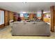 Spacious living room with a large sectional sofa and wood-paneled walls at 3415 Spot Rd, Cumming, GA 30040