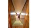 Carpeted staircase leading to a lower level with wood-paneled walls at 3415 Spot Rd, Cumming, GA 30040