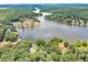 Lakefront property highlighting the lake, with a home nestled in mature trees in a serene setting at 590 Yancey Cir, Covington, GA 30014