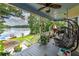 Serene porch view overlooking the lake, furnished with a hanging chair and potted plants, perfect for relaxation at 590 Yancey Cir, Covington, GA 30014