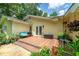 Inviting outdoor space featuring a wooden deck, with French doors, colorful potted plants and seating at 590 Yancey Cir, Covington, GA 30014