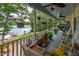 Picturesque lakefront porch featuring comfortable seating, hanging plants, and tranquil waterfront scenery at 590 Yancey Cir, Covington, GA 30014