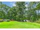 Large lush backyard with playset and shed at 590 Yancey Cir, Covington, GA 30014