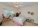 Cozy bedroom featuring a vintage spinning wheel, comfortable bed, and natural light from the window at 590 Yancey Cir, Covington, GA 30014